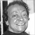 Joan Murrell Owens smiling, with short hair and wearing a black top.