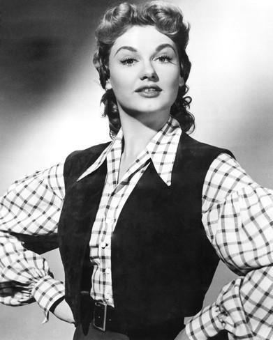 Joan Shawlee with her raised eyebrows wearing a long-sleeved shirt