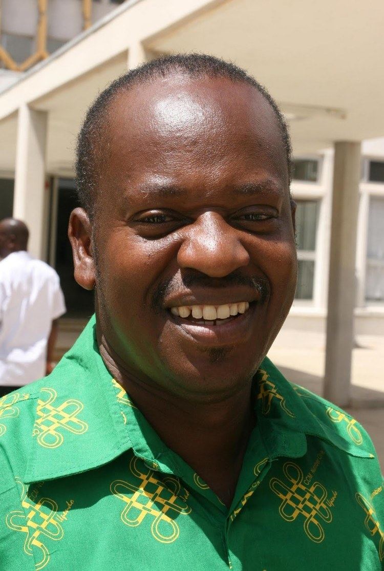 Job Ndugai smiling while wearing a green and yellow polo