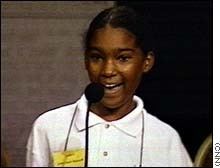 Jody-Anne Maxwell at a young age, smiling and wearing a white polo shirt.