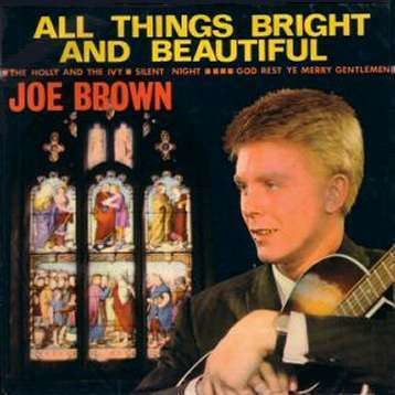 Poster of Joe Brown at a young age with blonde hair, wearing a black suit and black watch while holding a guitar.