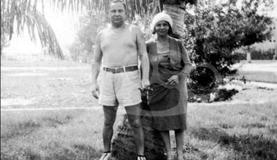 Joe Masseria posing with his wife with him wearing a white sleeveless shirt and short pants.