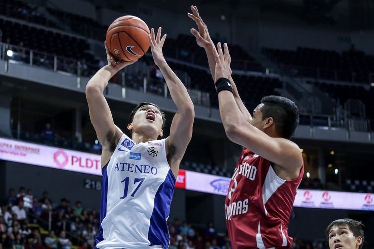 Son of John Apacible playing basketball wearing a jersey with his opponent wearing a red jersey.