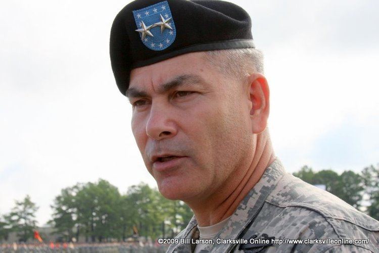 John F. Campbell wearing a combat uniform with a military cap