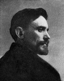 John Vanderpoel looking at the right side with a serious face, mustache, and beard while wearing a coat