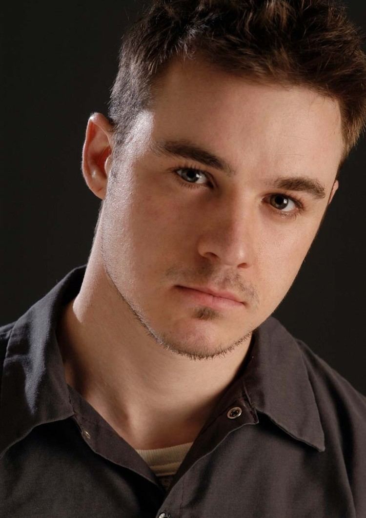 Jordan Christopher wearing a black collared shirt on his pictorial (close-up photo)