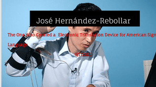 José Hernández-Rebollar talking to someone while wearing an electronic glove and blue long sleeves