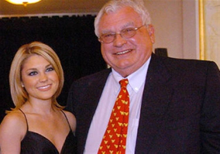 Joseph A. Hardy III in his black coat, white long sleeves, red and yellow neck tie with Kristin Georgi wearing black dress