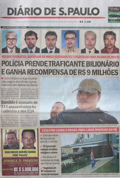 Juan Carlos Ramírez Abadía, featured in a newspaper while wearing a green cap and black sweatshirt