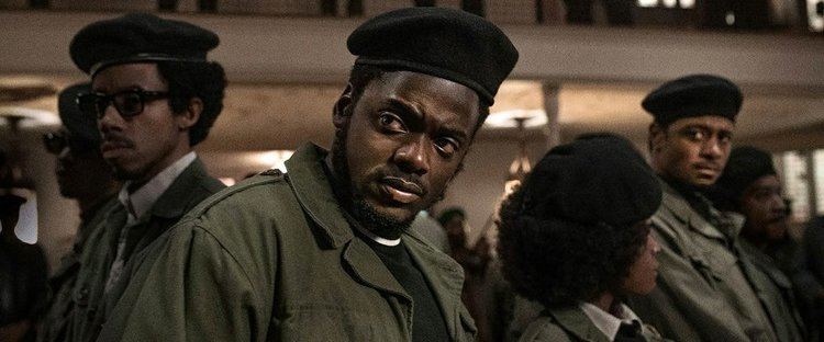 Darrell Britt-Gibson, Daniel Kaluuya, and LaKeith Stanfield wearing a black hat and army green coat in a scene from the 2021 film, Judas and the Black Messiah