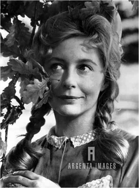 Young Judy Cornwell smiling with braided hair while wearing a blouse