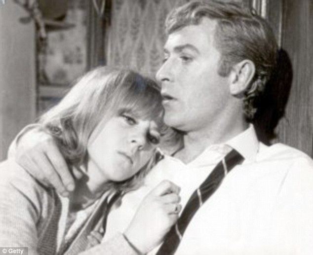 Michael Caine hugging Julia Foster while he is wearing a long sleeves and necktie