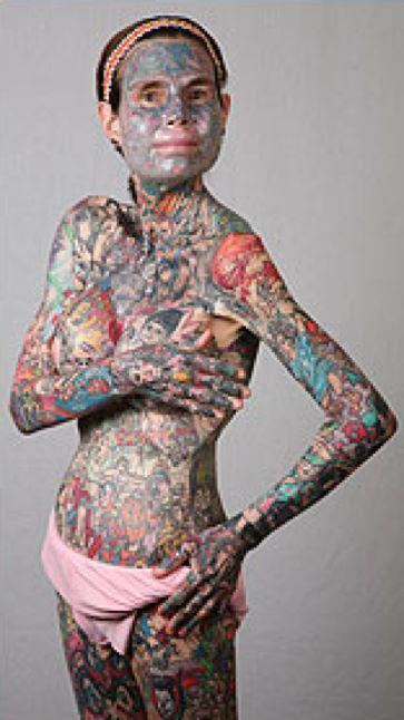 Julia Gnuse wearing a headband, pink underwear and covered her whole body with tattoos.