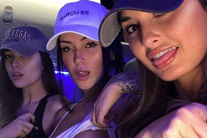 Julia Rose, Lauren Summer, and Kayla Lauren with gorgeous looks. Kayla wearing a black sleeveless top, Lauren wearing a sexy white top, and all of them wearing caps.