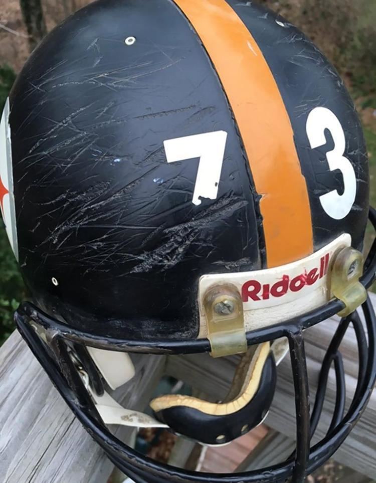 Justin Strzelczyk’s number seventy-three black and yellow helmet with brutal scars indicating a violent game