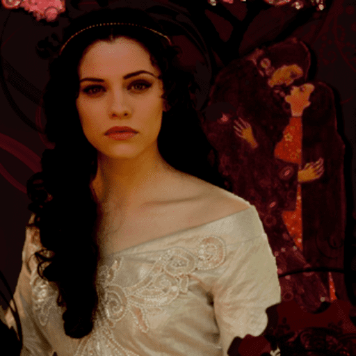 Jessica De Gouw as Jusztina Szilágyi's representation, with a serious face in front of a painting of a man and a woman looking and hugging each other intimately. Jessica with long curly black hair, wearing a headpiece and an off-white off-shoulder dress.