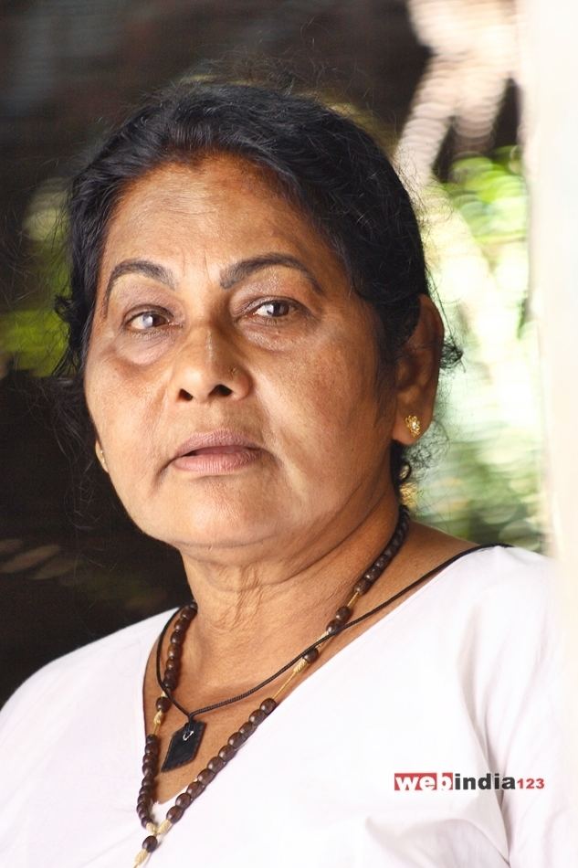 K. P. A. C. Lalitha wearing a white blouse, necklace, and earrings