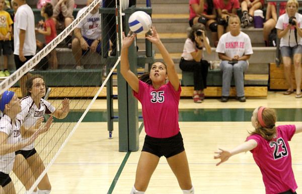 Kaleo Kanahele playing volleyball while wearing a hot pink t-shirt with number 35 and black shorts