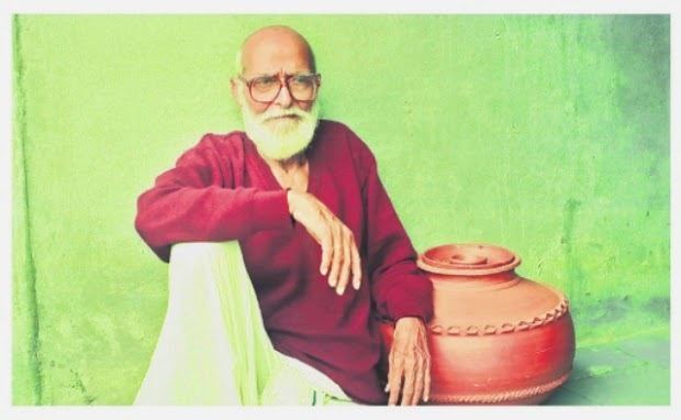 Kaloji Narayana Rao sitting with his mustache and long beard while his right arm on top of his knee