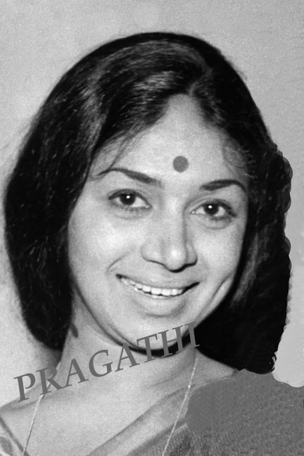 Kalpana smiling while wearing a blouse and necklace