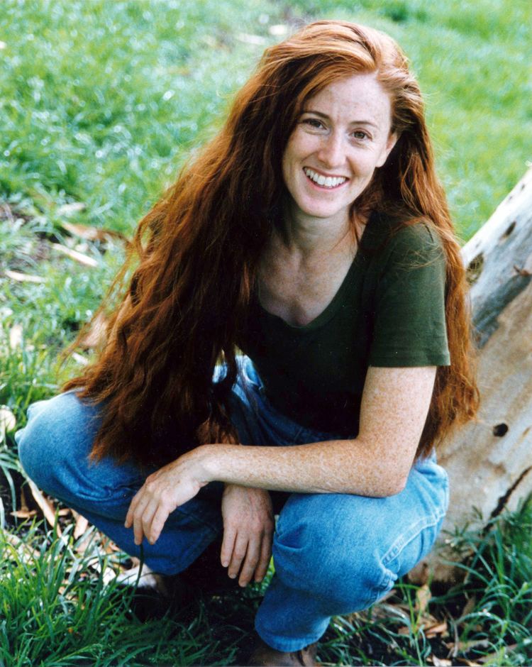 Kami Cotler wearing green t-shirt and blue jeans