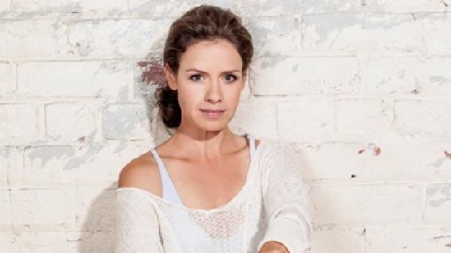 Kate Atkinson wearing a white blouse and white inner top