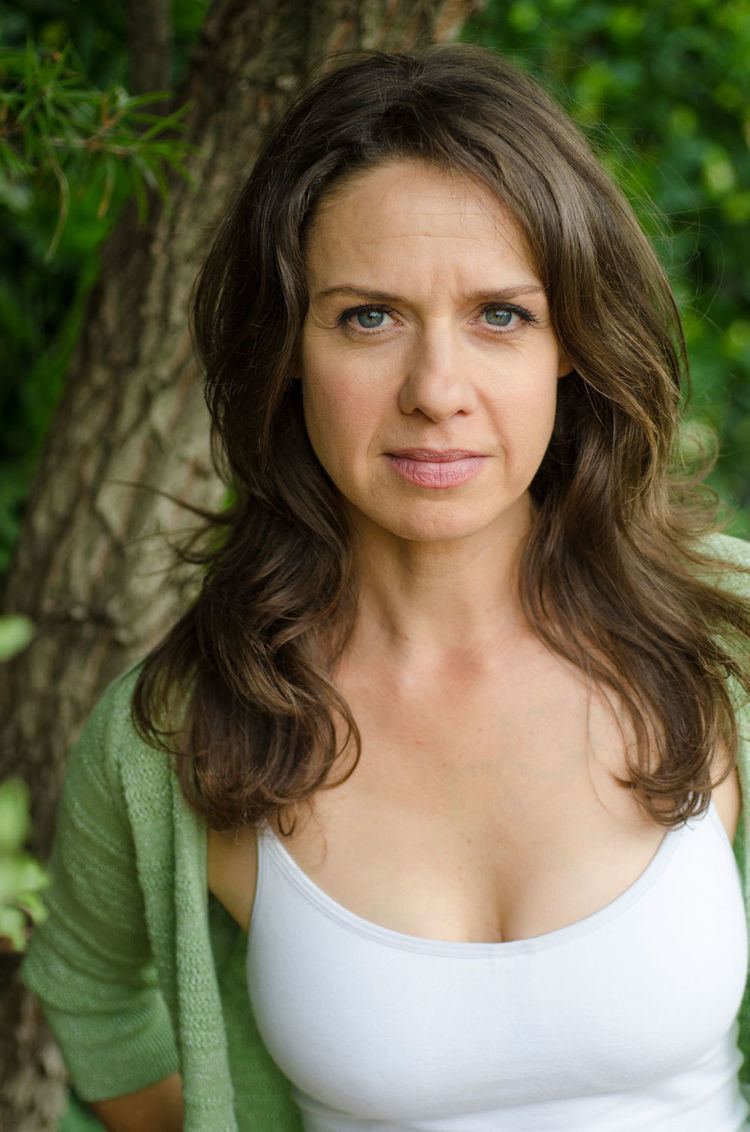 Kate Atkinson wearing green blazer and white top