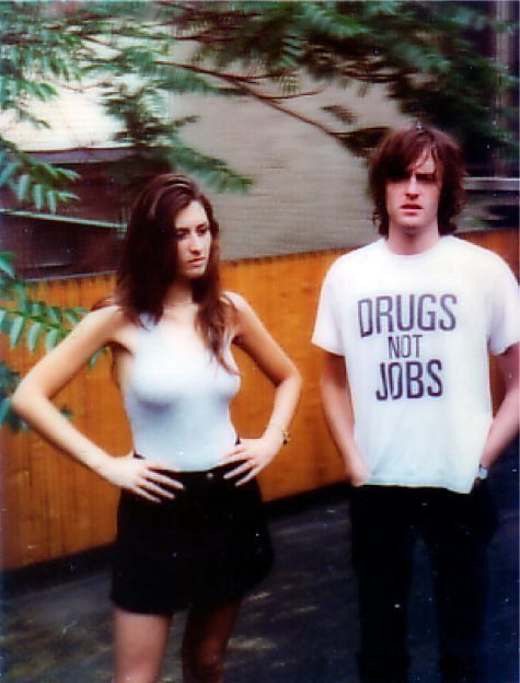 Kate Radley wearing a sleeveless top and a black skirt while Jason Pierce wearing a white shirt and black pants.