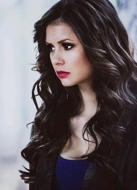 Katherine Pierce wearing black jacket and blue inner top