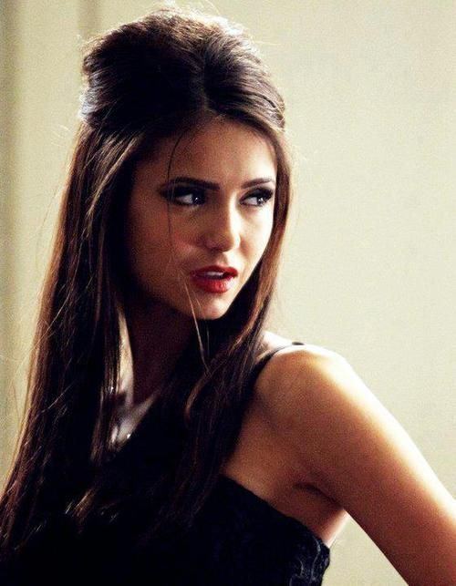 Katherine Pierce looking afar wearing black top