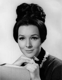 Kathryn Hays smiling with braided hair and wearing a blouse