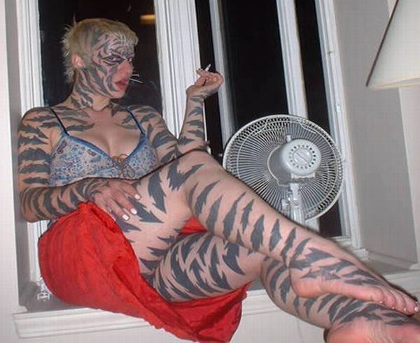 Katzen (performer) The tiger lady or Katzen is a performance artist and a tattoo artist