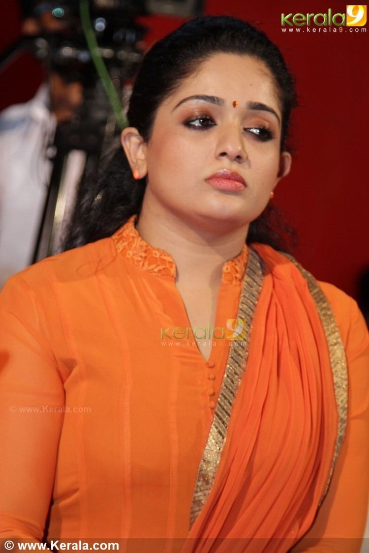 Kavya Madhavan wearing an orange sleeves