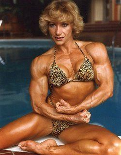Kay Baxter wearing a tiger-designed bikini while doing a "Side Chest" pose