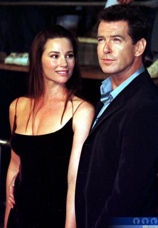 Keely Shaye Smith smiling and wearing a black sleeveless dress while Pierce Brosnan wearing a black coat and blue long sleeves
