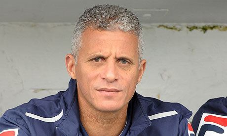 Keith Curle is serious, sitting in a room with white ceiling, he has gray hair wearing a dark blue shirt under a dark blue jacket with white lines and orange-red lines.