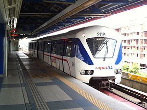In a train station, the Kuala Lumpur Metro called Rapid KL (stylized as rapidKL) is a public transport system built by Prasarana Malaysia and operated by its subsidiaries, covering the areas of Kuala Lumpur and the Klang Valley. Its color is white with blue-red lines and the number 209 on top.