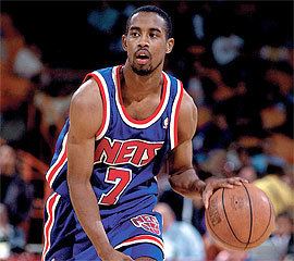 Kenny Anderson at a young age, wearing his uniform while playing basketball.