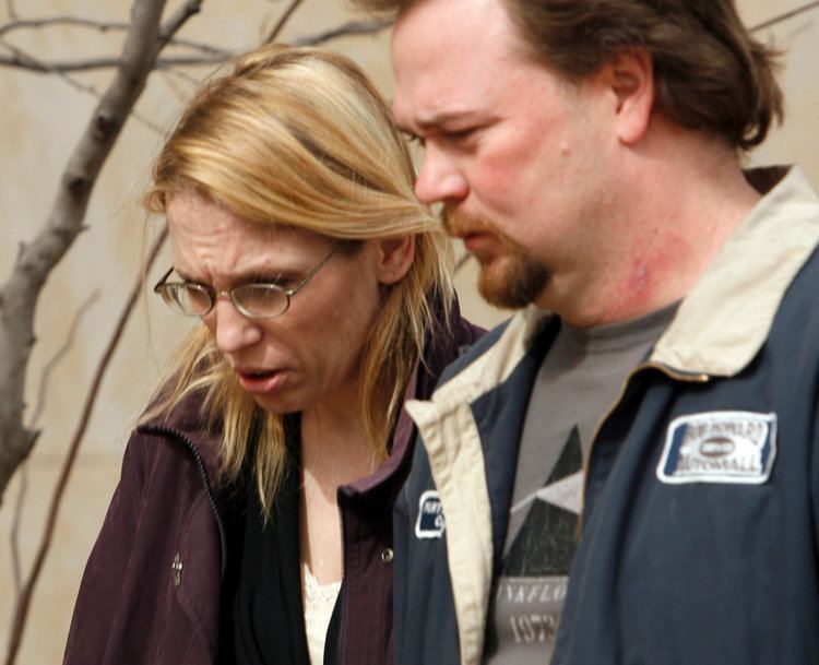 Jennifer Fox and Curtis Bolin with sad faces while leaving the courthouse after Kevin Ray Underwood was found guilty of the murder of their daughter Jamie Rose Bolin. Jennifer is wearing eyeglasses and a purple jacket while Curtis with a beard and mustache, wearing a blue and white jacket over a gray shirt.