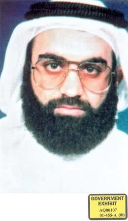 Khalid Sheikh Mohammed with mustache and beard while wearing eyeglasses, white long sleeves, white ghutra, and agal