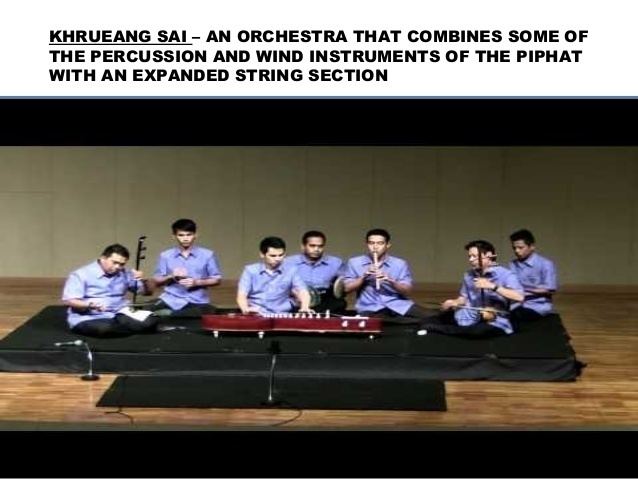 A group of men playing Khrueang sai and other Thai instruments while wearing a blue polo and black pants