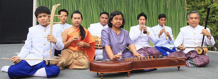 A group of people sitting on the floor while playing Khrueang sai and other Thai instruments