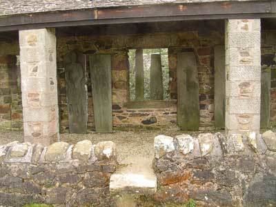 Kilberry Castle entrance:  display of carved burial slabs, etc., collected and placed within a shelter