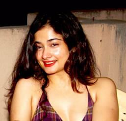 Kiran Rathod smiling and wearing a purple bikini bra.