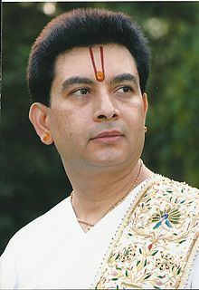 Kirit Bhaiji wearing white sleeves in a green background