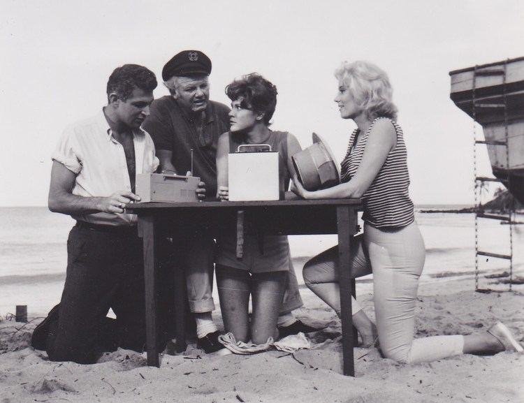 Alan Hale Jr., John Gabriel, Nancy McCarthy, and Kit Smythe talking to each other in a scene from the 1964 tv series, Gilligan's Island