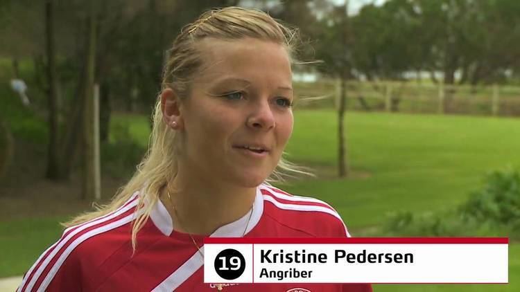 Kristine Pedersen, in one of her interviews, wearing a red and white jersey