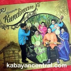 The CD album of Swinging the Kundiman by Rj Jacinto with men and women smiling and playing instruments while wearing a colorful barong and terno type of Maria Clara gown
