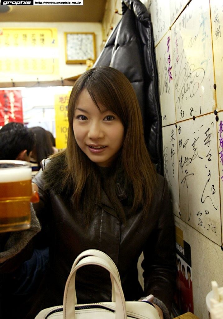 Kurumi Morishita smiling and holding her drinks while wearing black leather jacket