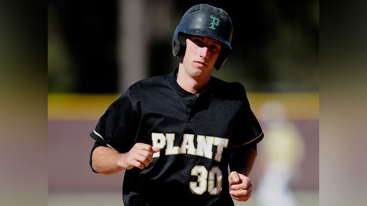 In a baseball field Kyle Tucker is serious, playing, running, wearing a black helmet, with P, a black Plant Jersey with Plant 30 printed.